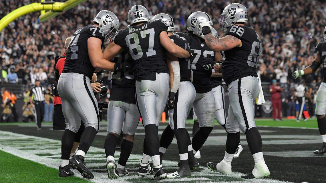 Las Vegas Raiders celebrate after scoring against the Los Angeles Chargers during the first half of an NFL game, Sunday, Jan. 9, 2022, in Las Vegas.