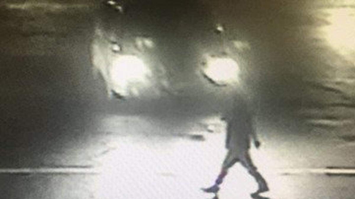 This image released by Fresno police shows the victim walking in crosswalk as the vehicle approaches her in fatal hit-run.