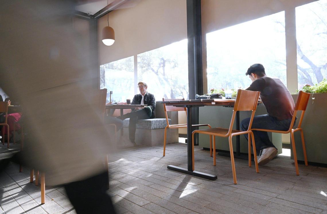 Customers relax in the enclosed patio of Otherside Cafe, Brandon Smittcamp and partners’ latest venture offering espresso drinks, food and desserts in northeast Fresno.