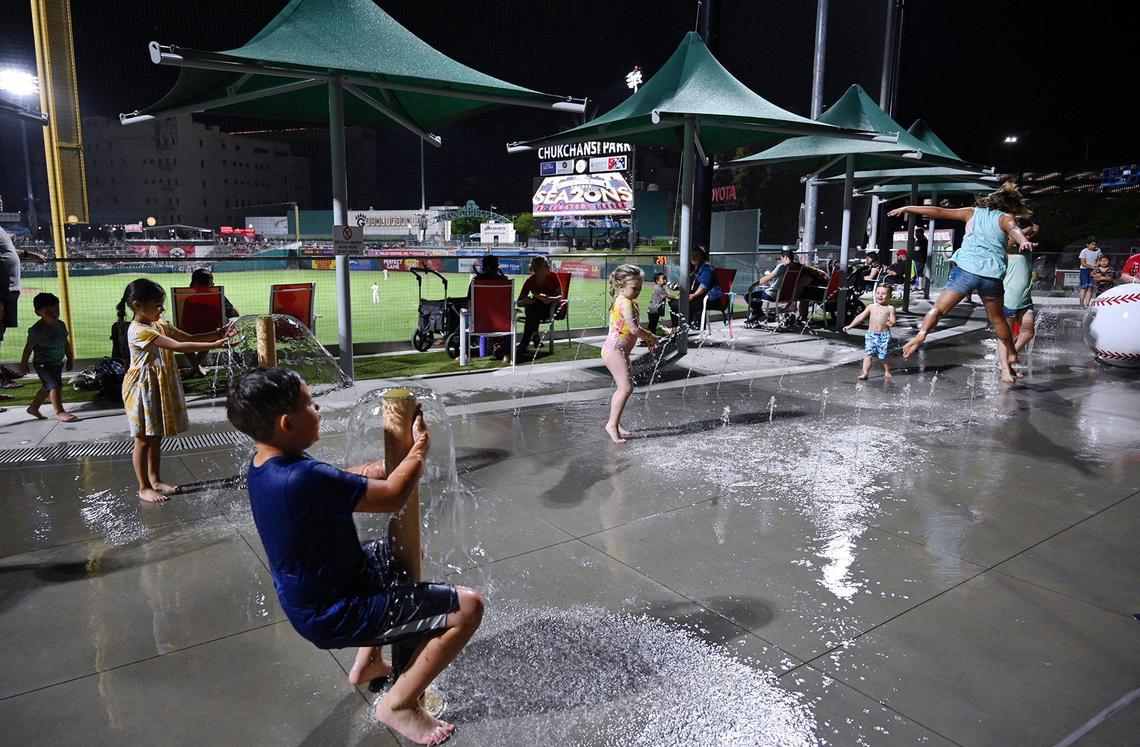 Kids play at the new Splash Park during the Fresno Grizzlies season opener against the Stockton Ports Friday, April 8, 2022 at Chukchansi Park in Fresno.