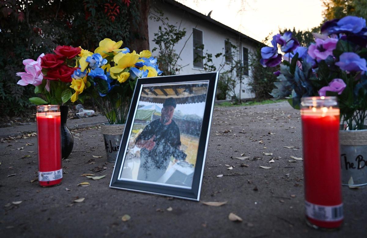 A photo of Frank Bond is seen in a driveway near where his body was found, as the community gathered for a candlelight vigil Friday evening, Jan. 12, 2024 in Reedley.