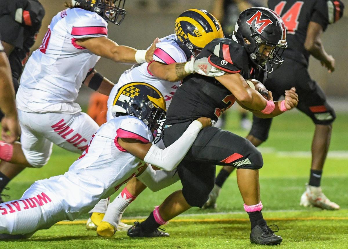 McLane’s Pearson Sengsoulinh gets pulled down by the Sunnyside defense on a run during their football game at McLane Stadium on Friday, Oct. 21, 2022.