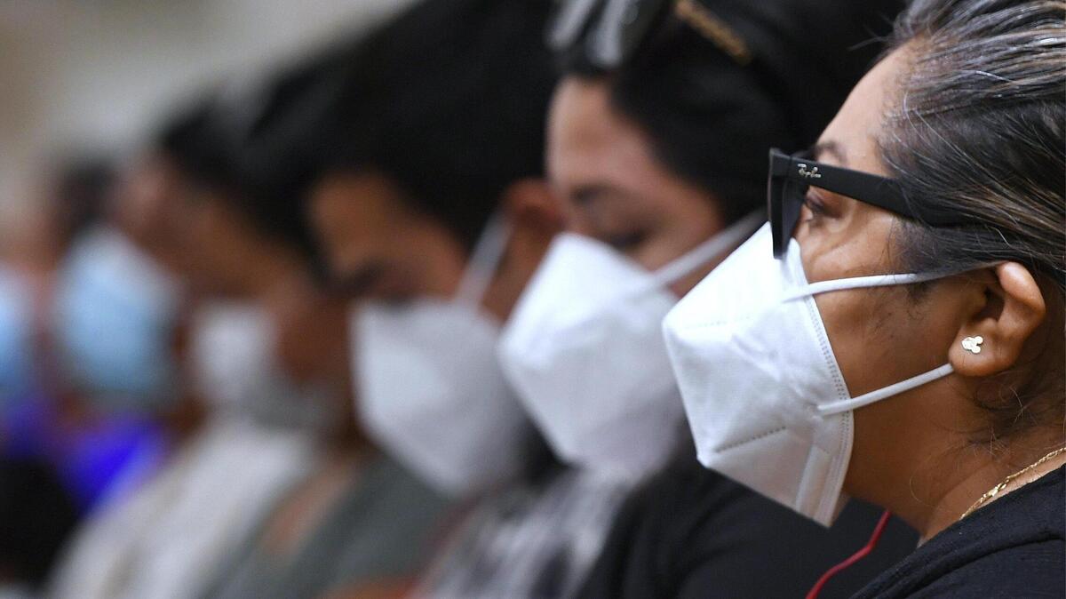 A row of masked attendees at Fresno City Hall.