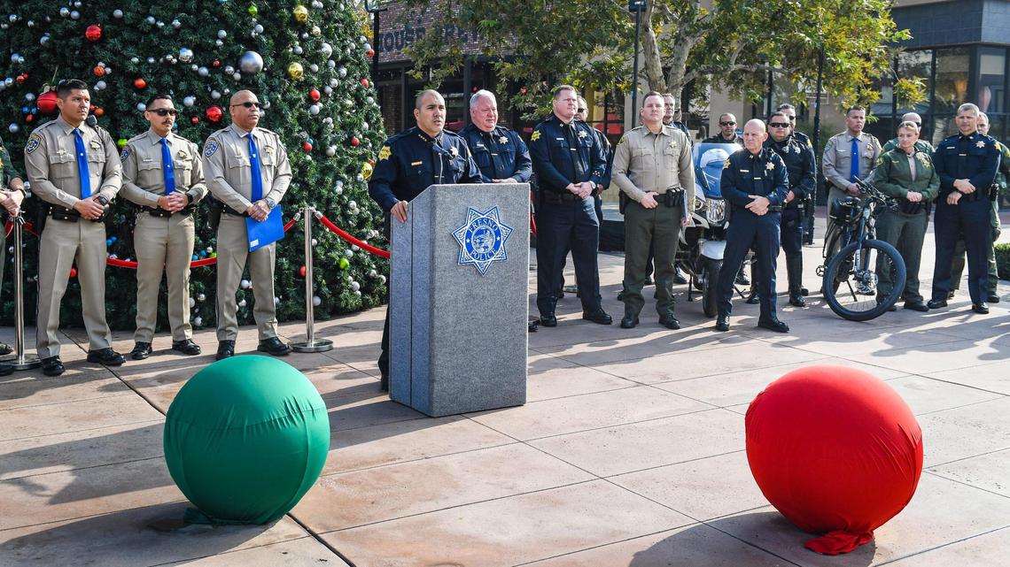 Fresno Police chief Paco Balderrama stands with members of the Fresno Police Department, the Fresno County Sheriff’s Office and the California Highway Patrol while announcing the start of the agencies’ annual Operation Christmas Presence initiative at River Park shopping center in Fresno on Wednesday, Nov. 24, 2021.