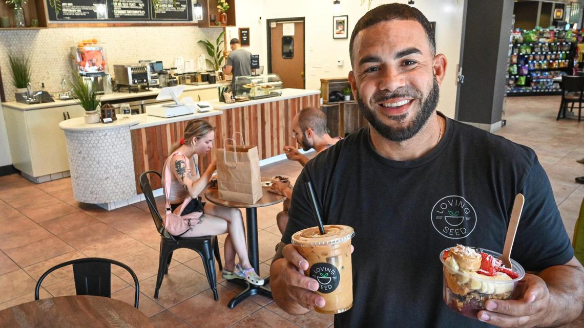 Justin Henry, owner of Loving Seed, holds a cold brew and açai bowl from the cafe’s first brick-and-mortar location, which opened in 2022. It recently opened a second Fresno location at Champlain Drive and Perrin Avenue.