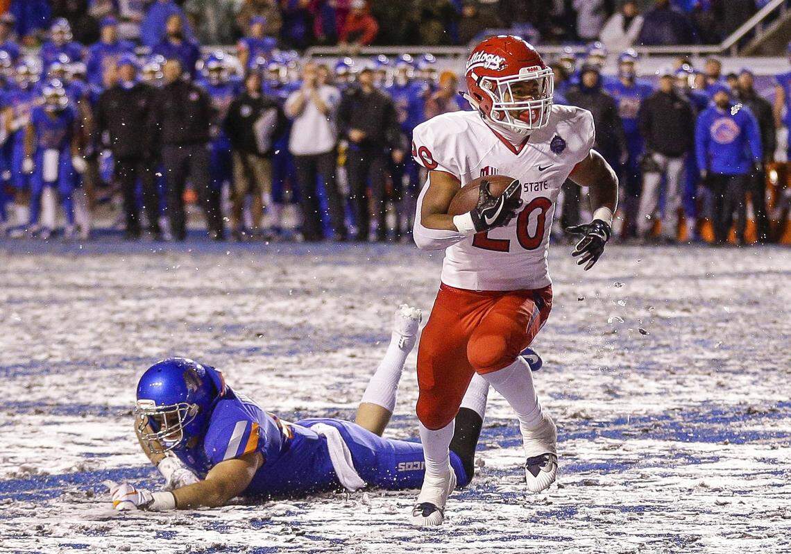 Fresno State running back Ronnie Rivers runs past the diving tackle attempt by Boise State linebacker Will Heffner in scoring a game-winning touchdown in the Bulldogs’ 19-16 victory at Boise State in the 2018 Mountain West championship game.