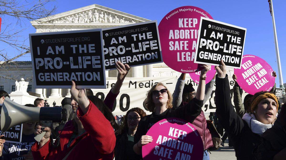 Protesters on both sides of the abortion issue gather outside the Supreme Court in Washington, D.C. on Jan. 19, 2018, during the March for Life. The march -- which typically draws busloads of Catholic school students, a large contingent of evangelical Christians and poster-toting protesters of many persuasions -- falls each year around the anniversary of the 1973 Roe v. Wade decision that recognized a legal right to abortion and intends to pressure Congress and the White House to limit legal access to the procedure.