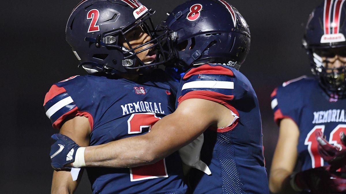 San Joaquin Memorial’s TJ Hall, left, is held back by Brandon Ramirez, right, in a heated moment against Garces Memorial in the Central Section Division I playoffs Friday, Nov. 12, 2021 in Fresno.