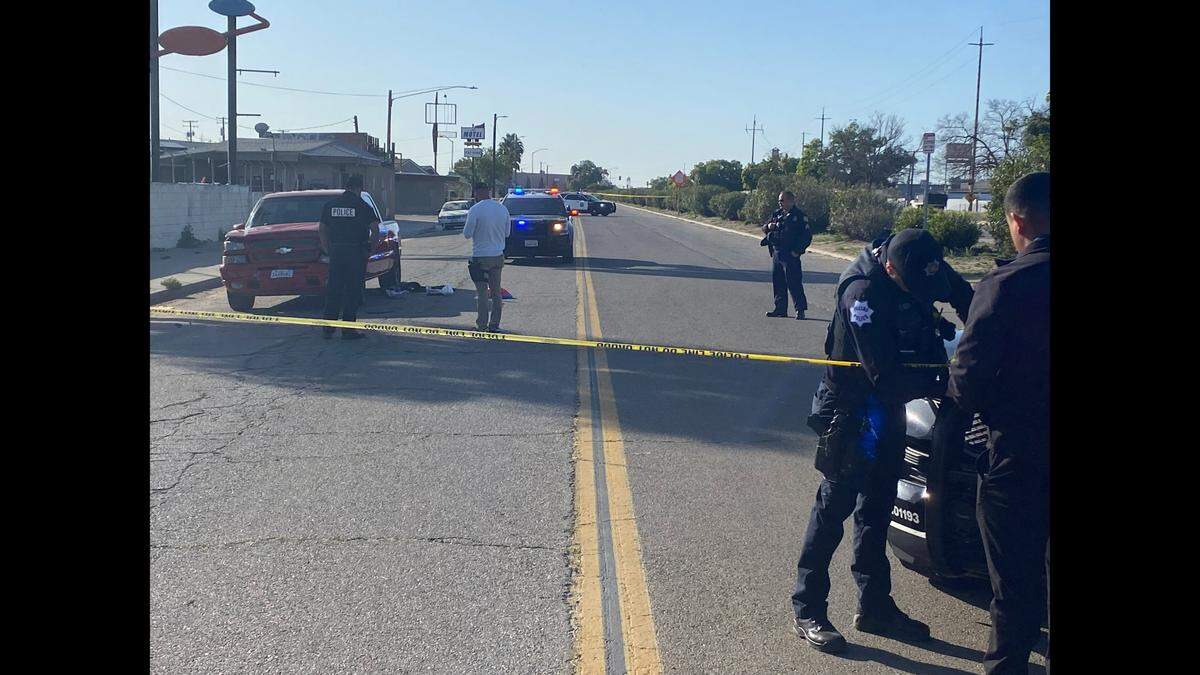 Officers investigate where a man was shot on G Street near Church Avenue in Fresno on Wednesday, April 19, 2023.