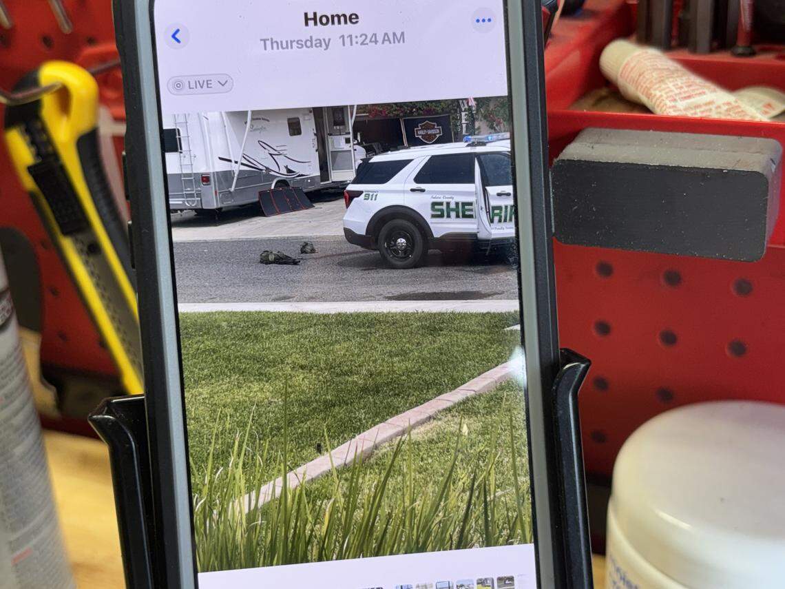 Juan Alvarado, a resident on West Brian Avenue, shows an image on Monday, April 13, 2026 that was taken on his phone showing where a deputy was shot and killed in north Porterville on April 9. 