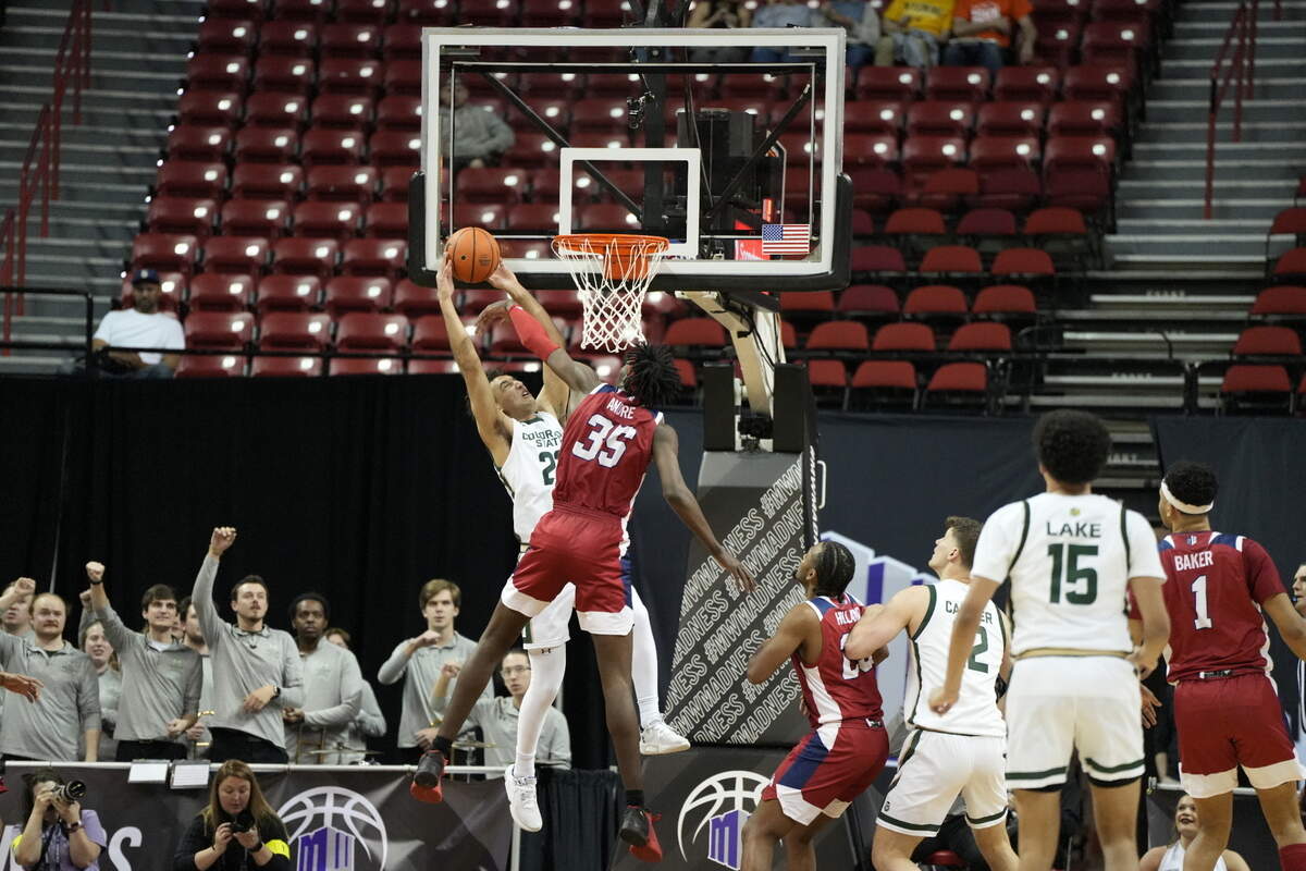 Fresno State center Eduardo Andre blocks a shot by Colorado State’s Isaiah Rivera in the Bulldogs’ 67-65 loss to the Rams in the first round of the Mountain West Conference Tournament.
