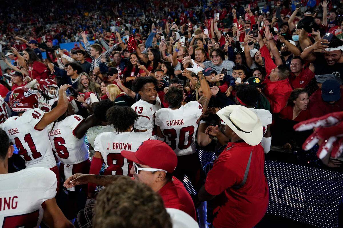 Fresno State Players celebrate with fans after a win over UCLA in an NCAA college football game Sunday, Sept. 19, 2021, in Pasadena, Calif. (AP Photo/Marcio Jose Sanchez)