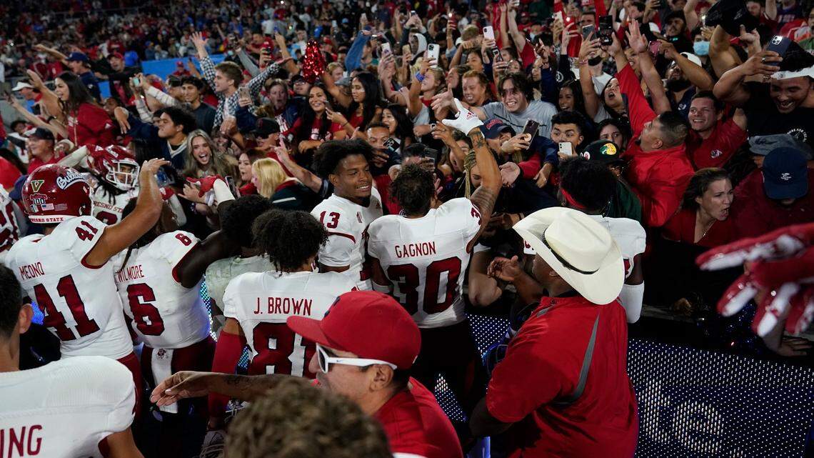 Fresno State Players celebrate with fans after a win over UCLA in an NCAA college football game Sunday, Sept. 19, 2021, in Pasadena, Calif. (AP Photo/Marcio Jose Sanchez)
