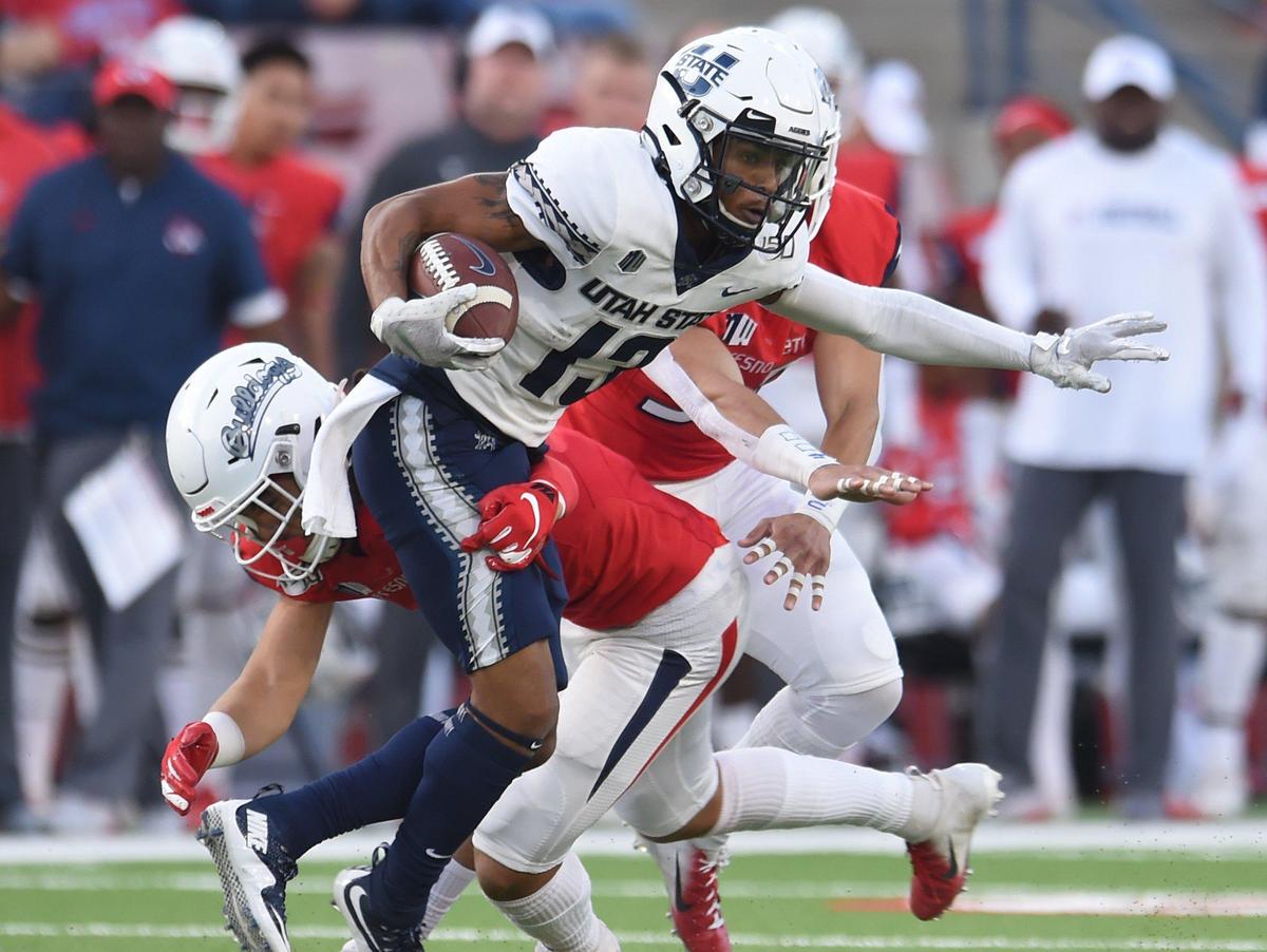 Utah State’s Deven Thompkins, right, eludes Fresno State freshman linebacker Levelle Bailey in a 37-35 victory over the Bulldogs, Saturday, Nov 9, 2019 in Fresno.