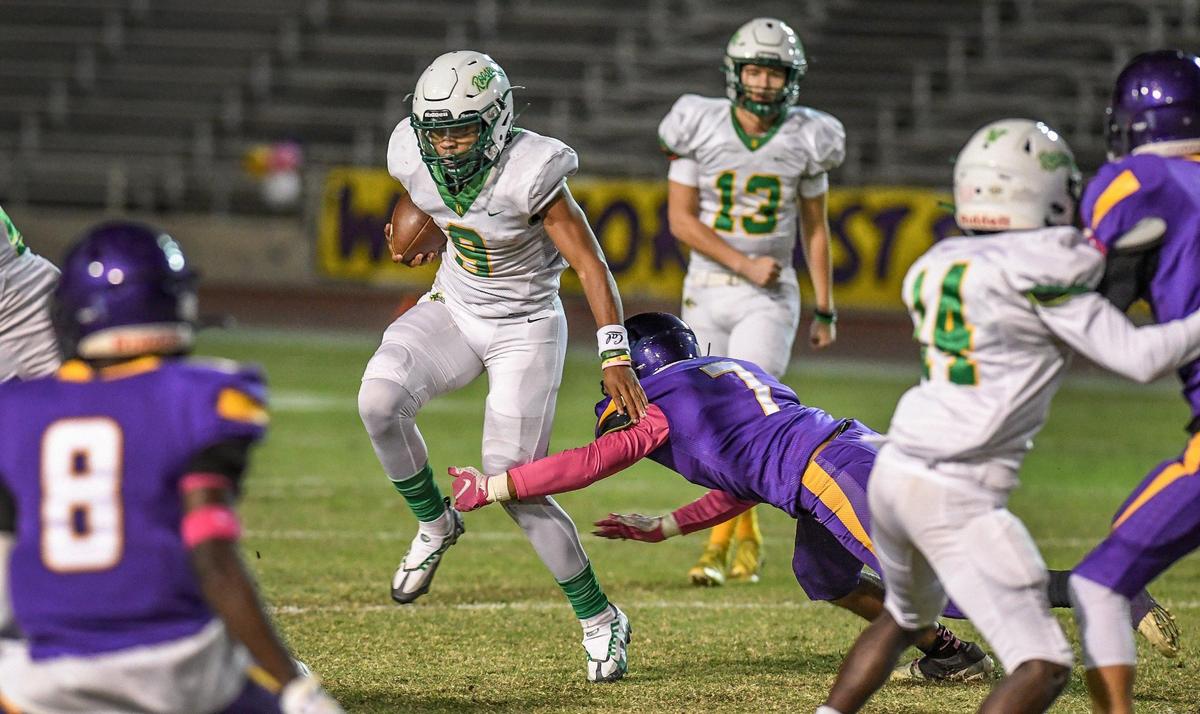 Roosevelt’s Michael Gonzales tries to evade a tackle by Fresno’s Joel Maxwell during the 92nd annual Little Big Game between the two schools at Ratcliffe Stadium in Fresno on Friday, Oct. 28, 2022.