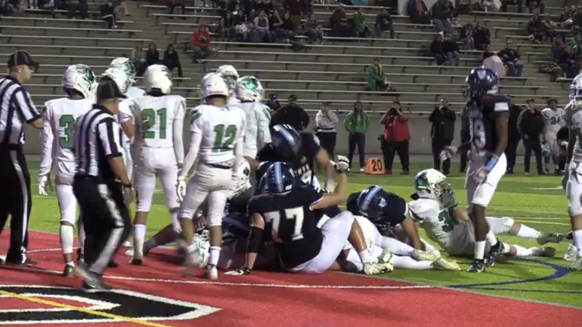 Bullard High quarterback Roland Russo is in the pile after he converted on a two-point conversion in Bullard’s 29-28 win over St. Joseph in a Central Section Division II game.