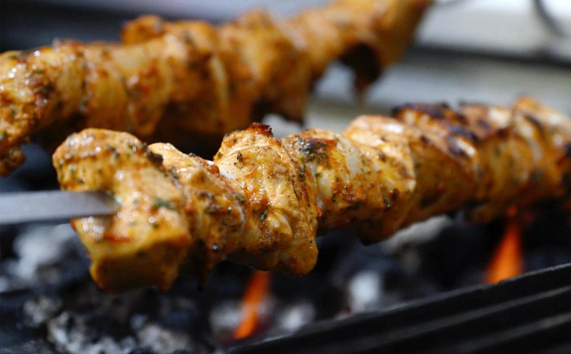 Skewers of Chicken Kabob are grilled over flame at Tete’s Kitchen serving up Mediterranean food at the corner of Pollasky Avenue and 4th Street in Old Town Clovis. Photographed Thursday, July 10, 2025.