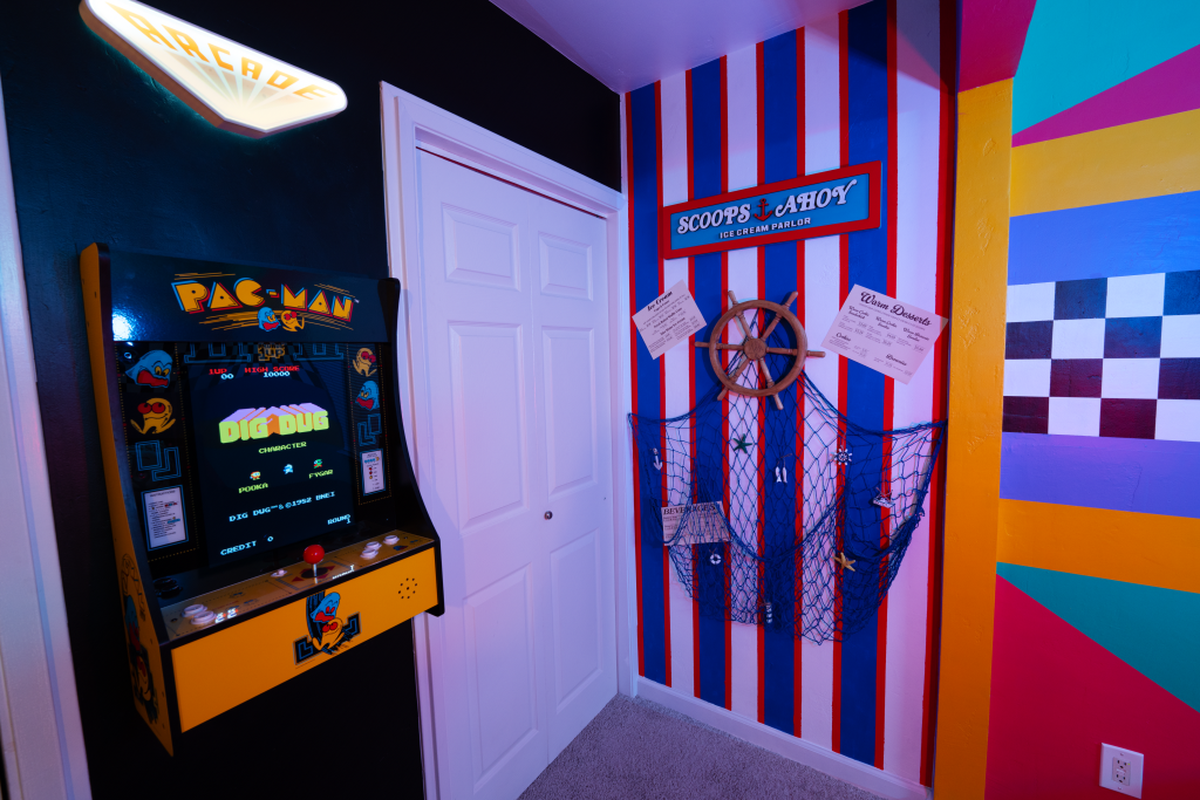 A bedroom in a “Stranger Things”-themed house in Clovis features a “Pac Man” video arcade game and other decor reminiscent of the 1980s.
