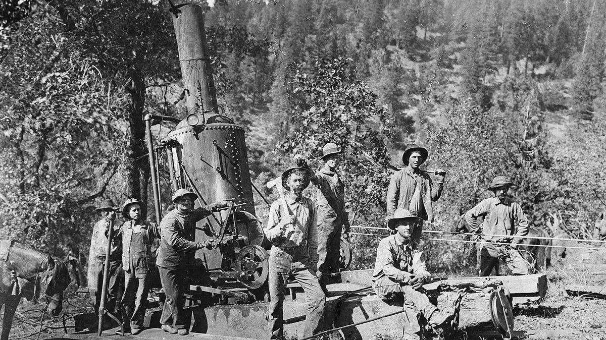 A Shaver logging crew, circa 1900, with a “donkey” engine, which was a steam engine used to power a winch pulled logs after they were cut in a forest.