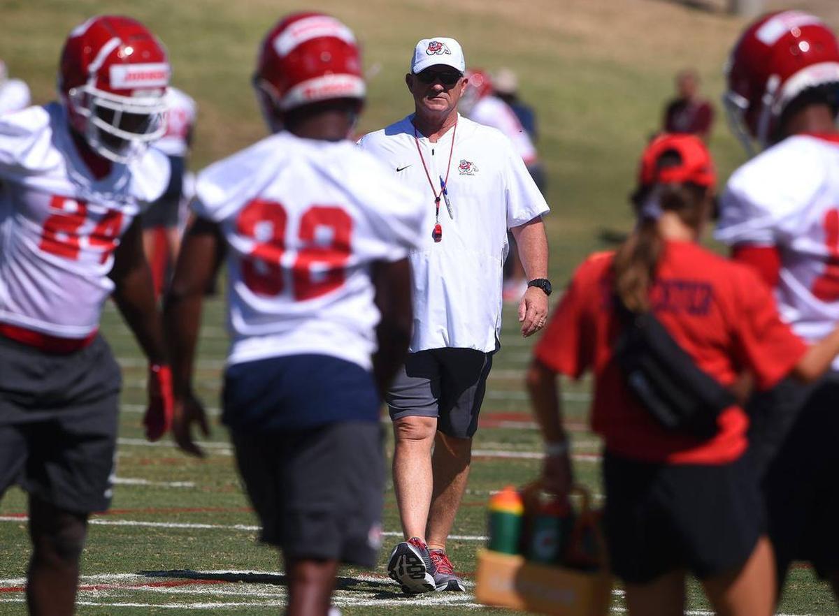 Fresno State head coach Jeff Tedford, center, surveys the practice field on the first day of preseason camp. The Bulldogs went 4-8 in his final season at his alma mater.