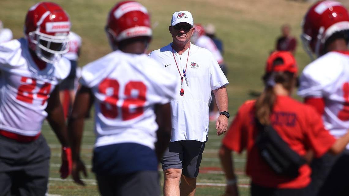 Fresno State head coach Jeff Tedford, center, surveys the practice field on the first day of preseason camp. The Bulldogs went 4-8 in his final season at his alma mater.