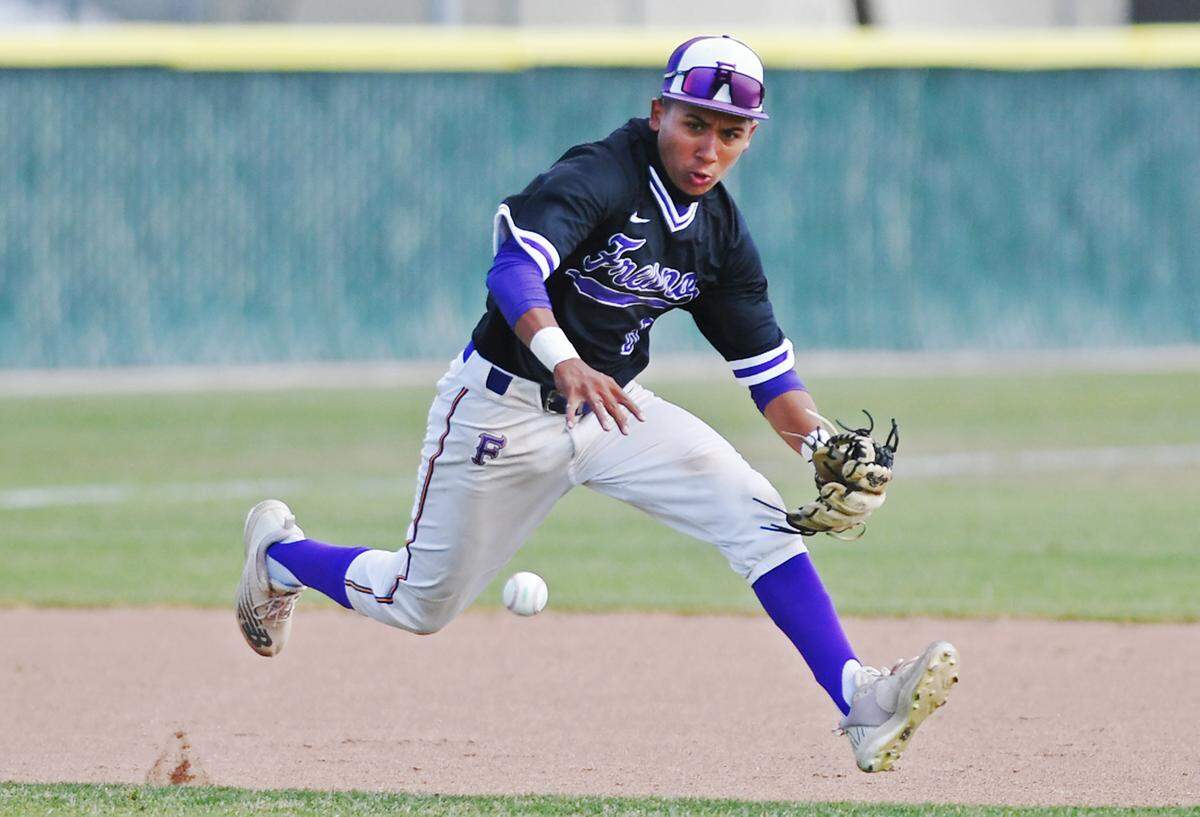 Fresno High’s Richie Rosas fields a hit by McLane in a matchup Friday, April 22, 2022 in Fresno.