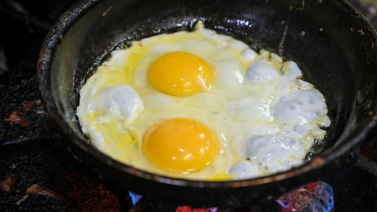 Eggs fry in a pan at Al’s Cafe in Fresno where soaring egg prices have forced the restaurant to increase menu prices to make up for the thousands of dollars spent on eggs alone.