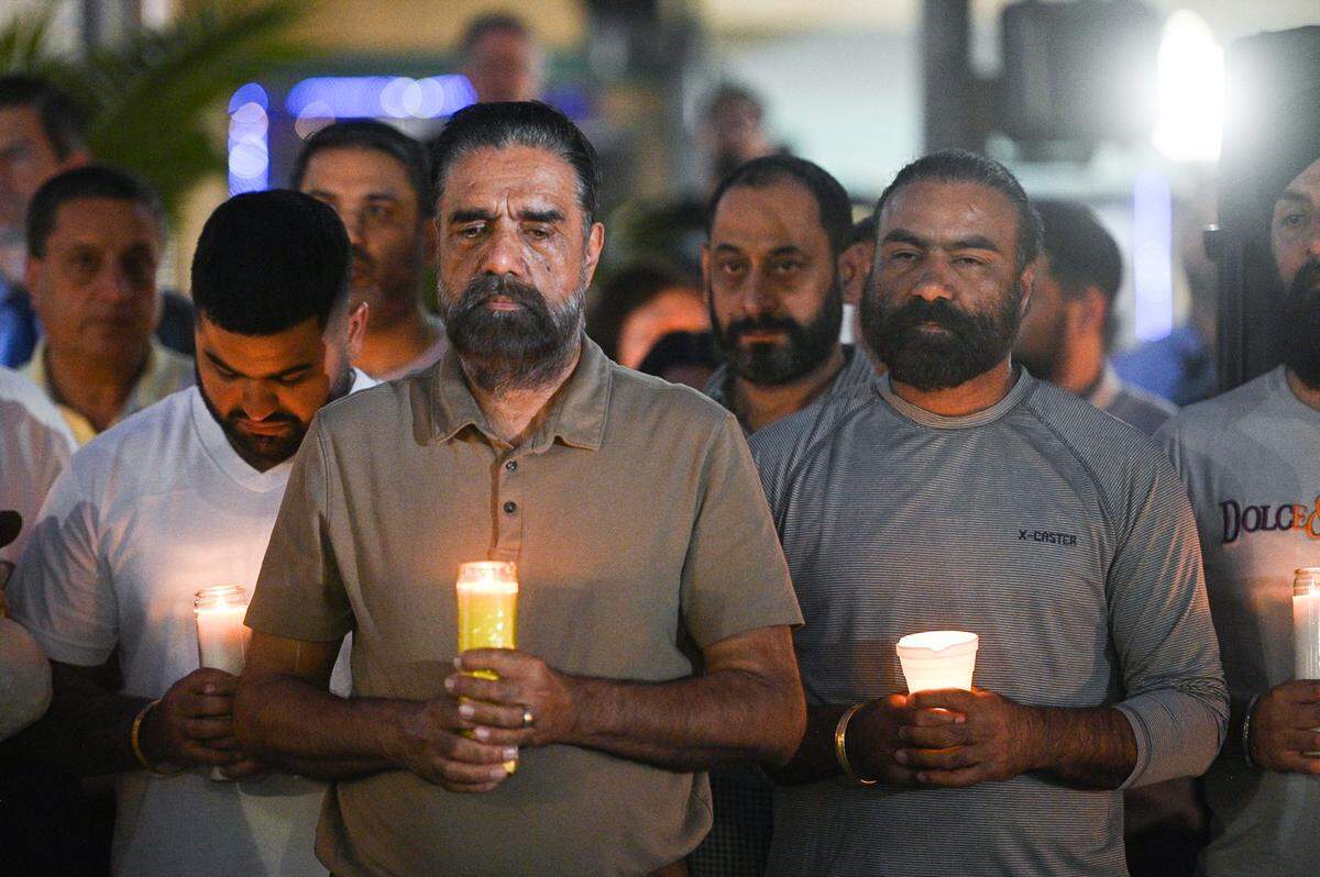 Mourners gather in Merced’s Bob Hart Square on Thursday to remember four family members who were kidnapped at gunpoint and murdered.