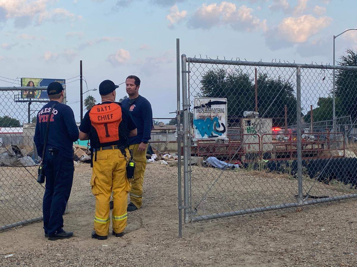 Firefighters look over a canal where a body was discovered about 6:30 a.m. Thursday, Sept. 21, 2023, near Millbrook and McKinley avenues in Fresno.