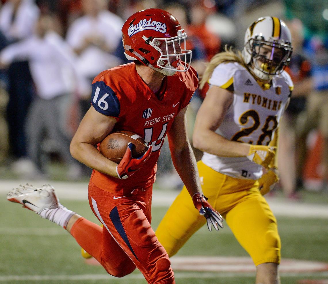 Fresno State tight end Jared Rice, left, runs past Wyoming’s Andrew Wingard for a first half touchdown in the Bulldogs’ 27-3 victory over the Cowboys at Bulldog Stadium in Fresno on Saturday, Oct. 13, 2018. Rice caught seven passes for 94 yards and the touchdown.