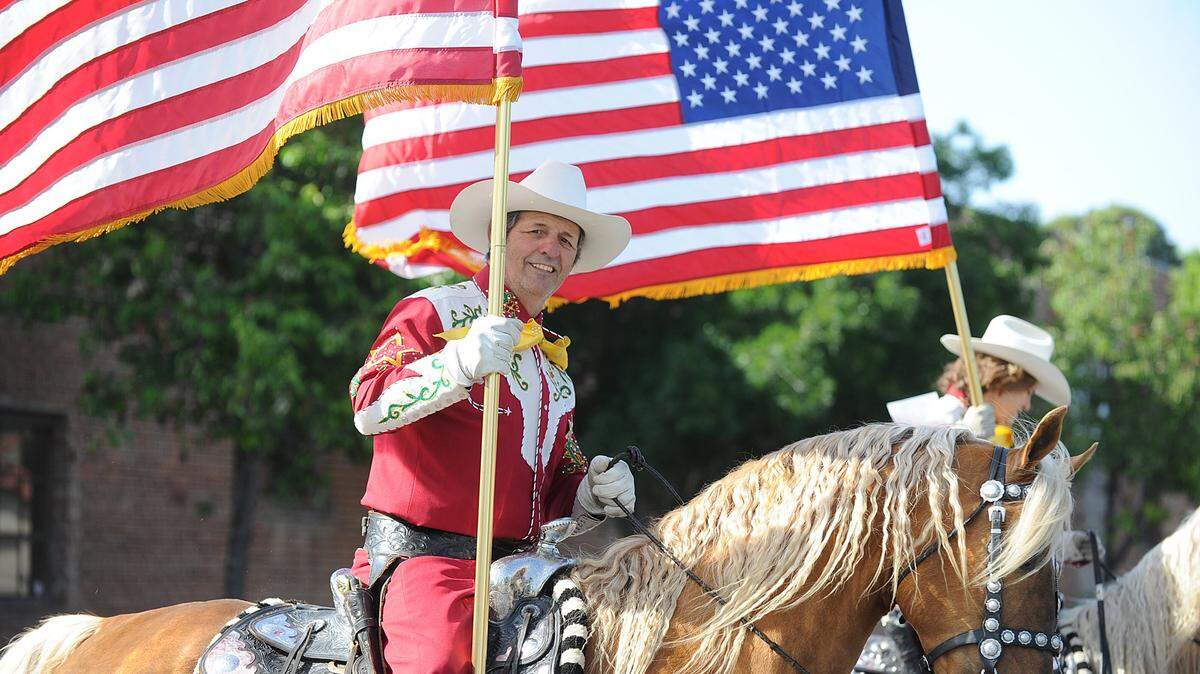 A member of the Merced County Mounted Sheriff’s Posse displays the colors at the Merced County Spring Fair downtown parade in Los Banos in 2017. Due to the threat of coronavirus, fair officials on Wednesday announced this year’s Spring Fair is canceled. For the full story, go to www.losbanosenterprise.com. 