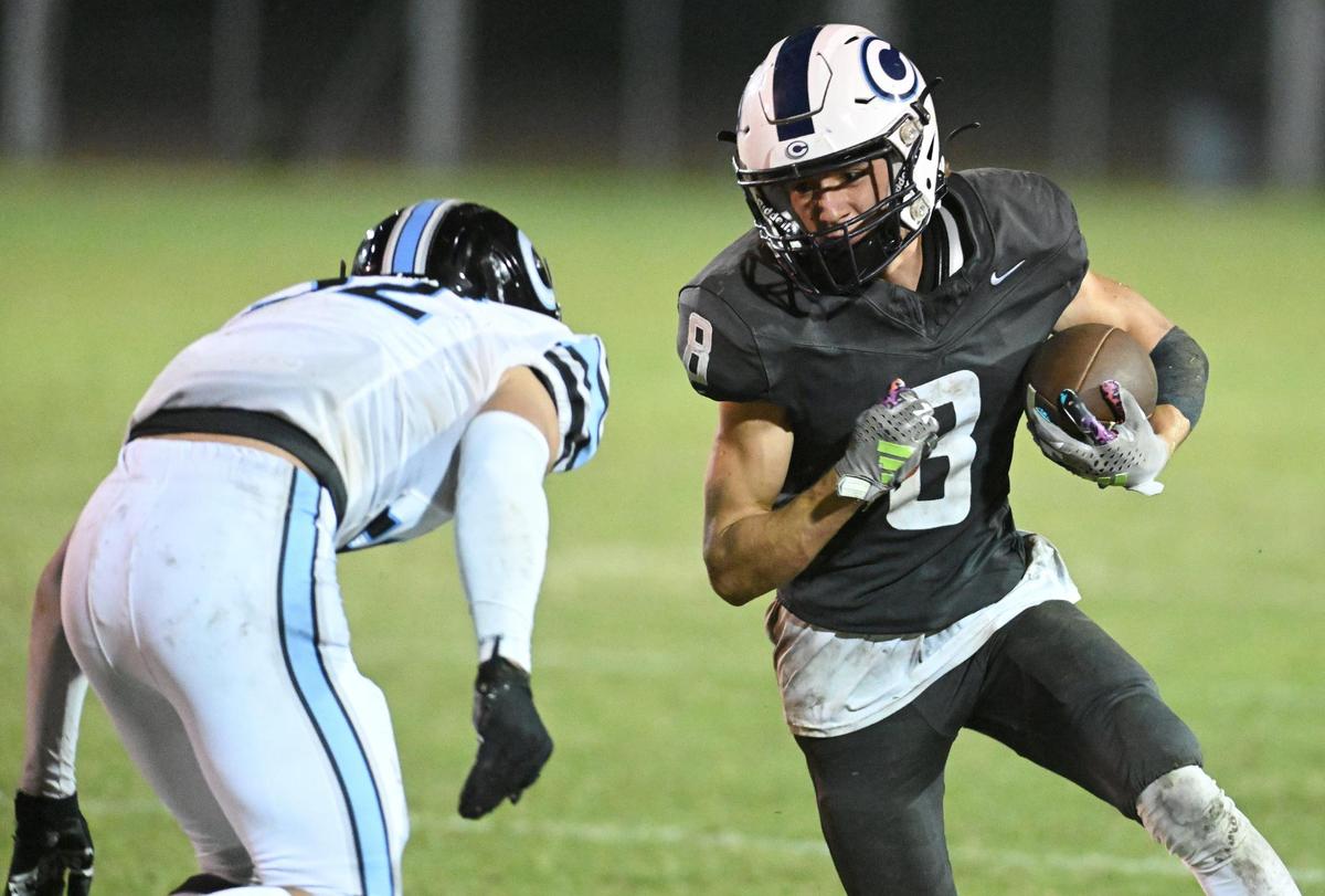 Central Valley Christian’s Micah Baden, right, tries to turn the corner against Clovis North during their game at CVC on Friday, Sept. 8, 2023.