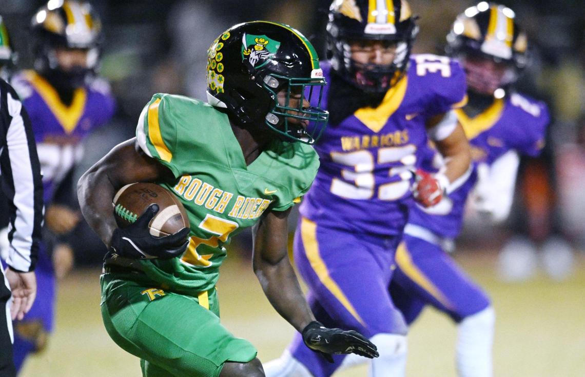Roosevelt’s Andy Acevedo, left, runs the ball against Fresno High Friday, Nov. 1, 2024 in Fresno. Roosevelt won 54-12.