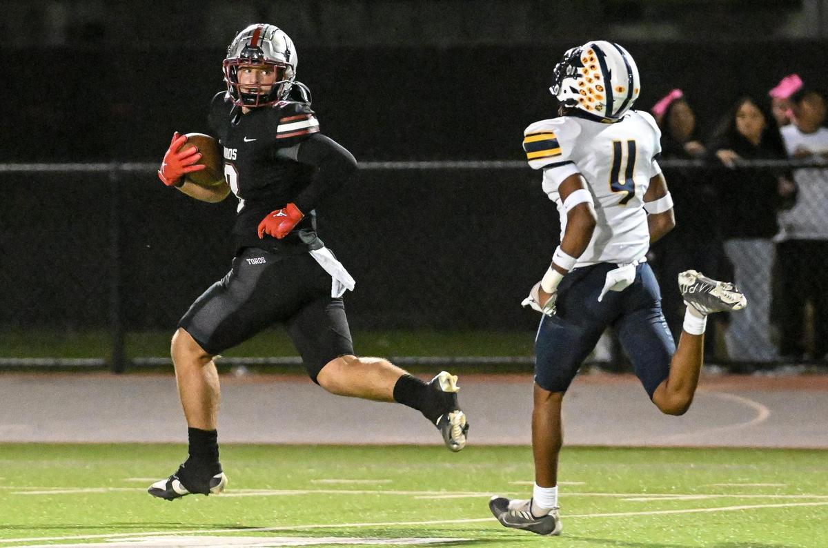 Torres’ Joseph Bass, left, looks back toward Sunnyside defender Deeondre Johnson while running for his second touchdown of the night at the Madera South High School football stadium on Friday, Oct. 13, 2023.