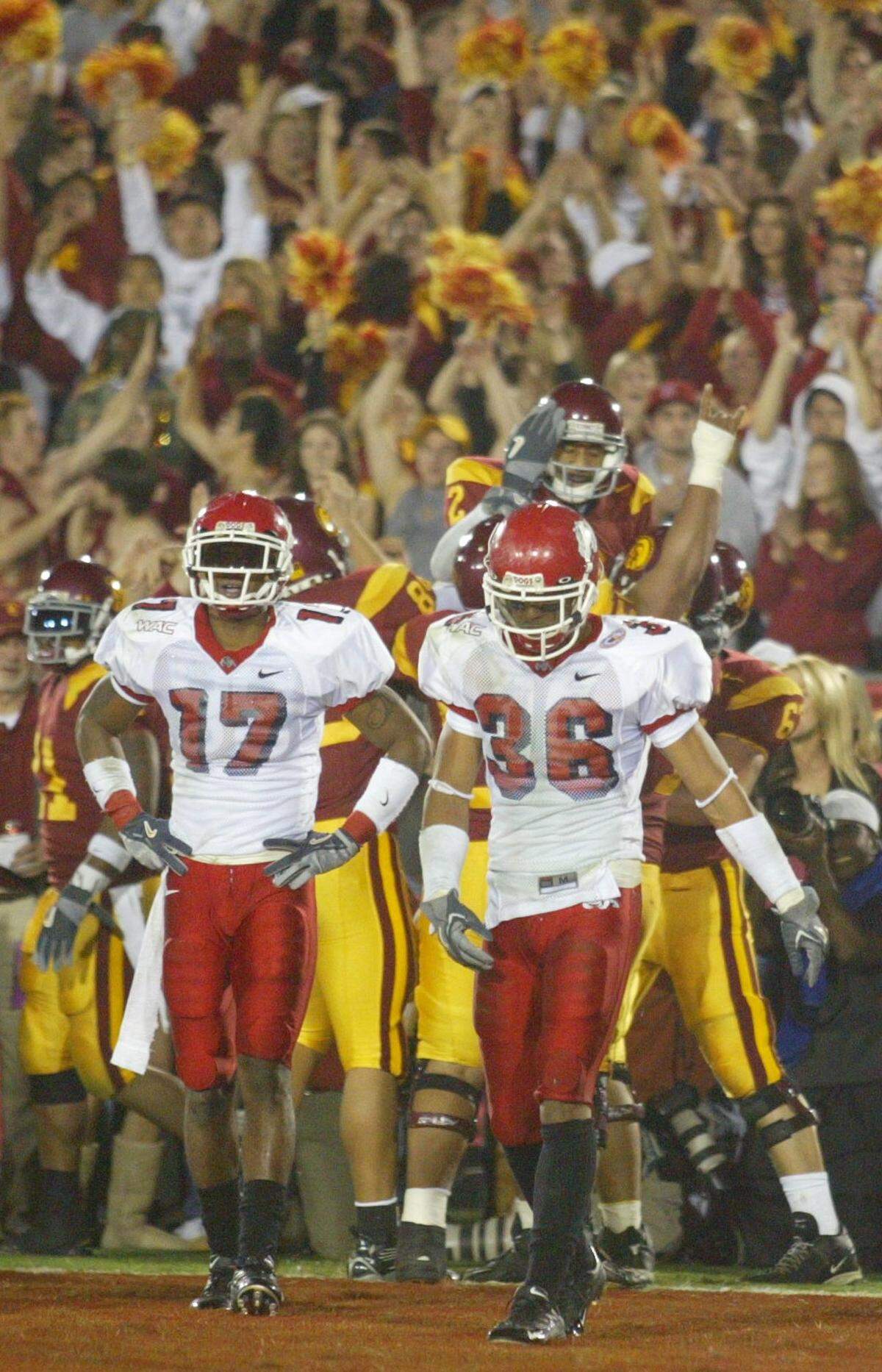 Fresno State's Marcus McCauley, left, and Tyrone Culver walk away after failing to defend a td pass to USC's #2 Steve Smith during the third quarter.