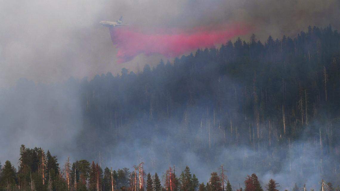 Fire retardant is dropped on the Washburn Fire as it burns in late afternoon light near the south entrance of Yosemite National Park Saturday, July 9, 2022 near Fish Camp.