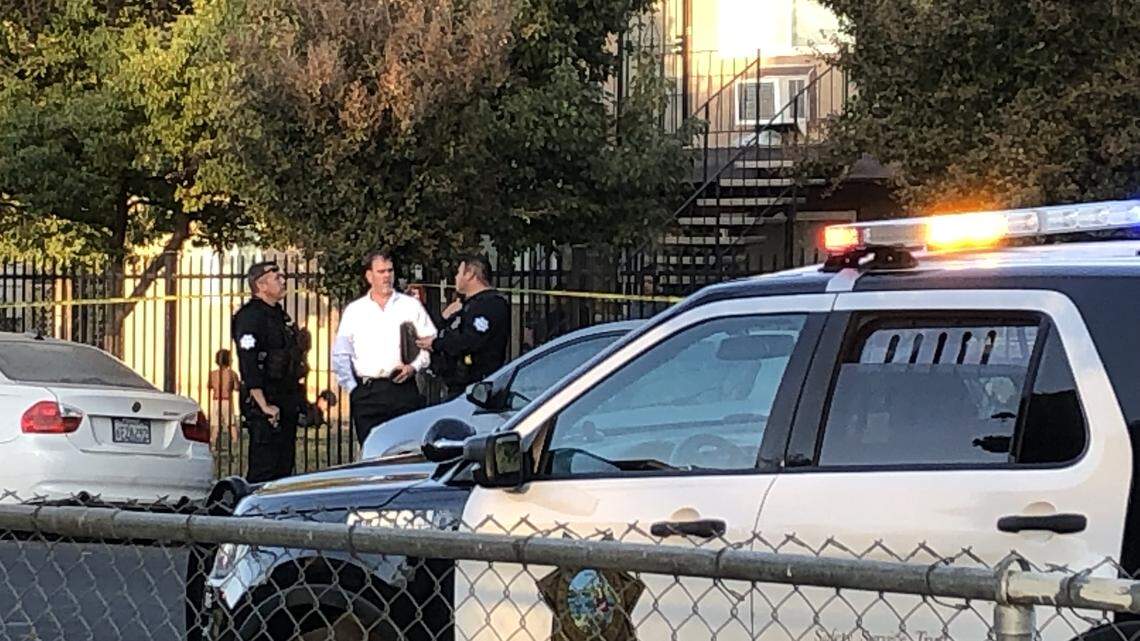 Fresno Police investigators talk outside an apartment complex at Rowell and Hedges avenues, where a 14-year-old boy was shot in the leg in a fusillade of gunfire Tuesday afternoon, Nov. 5.