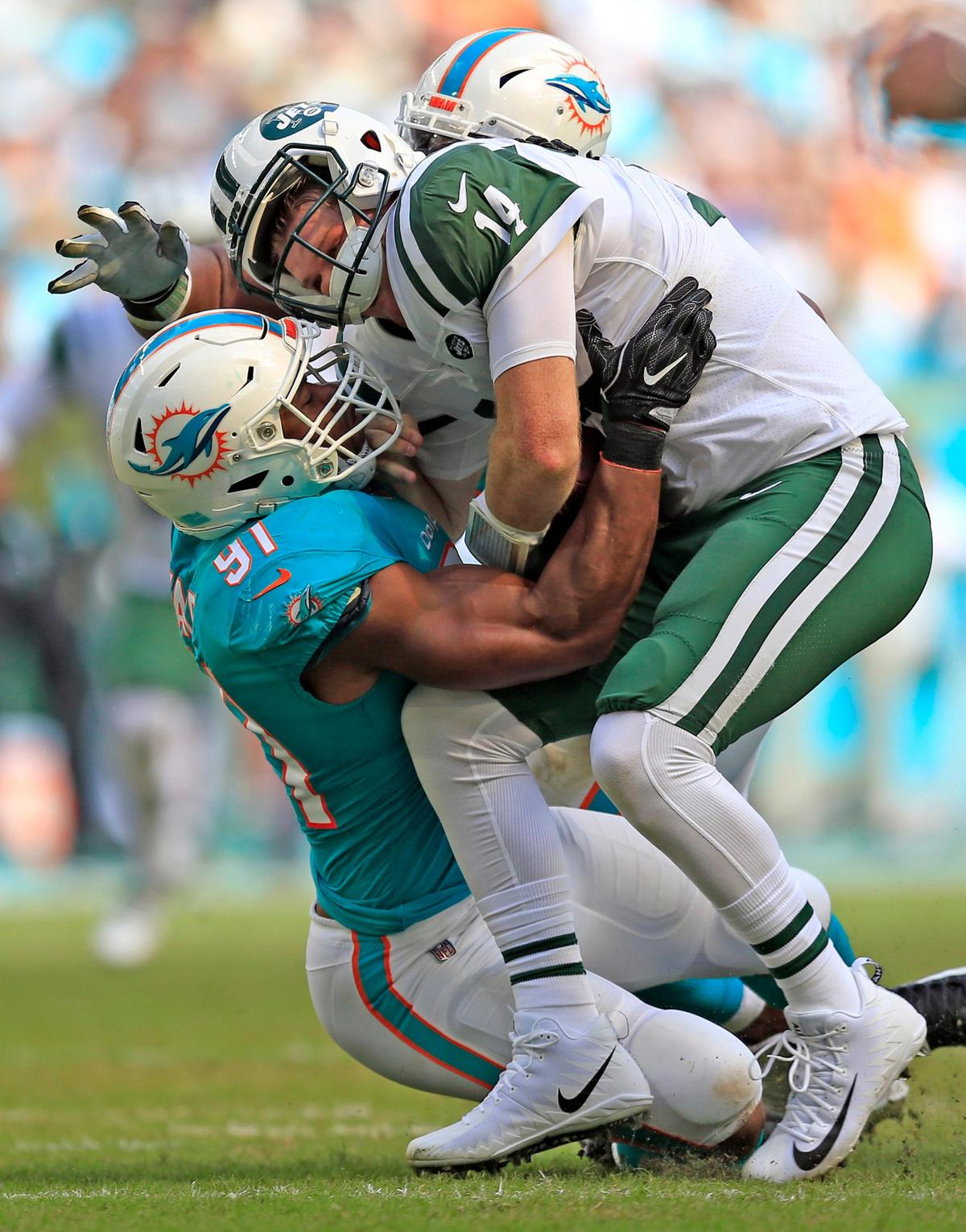 Miami Dolphins defensive end Cameron Wake (91) tackles New York Jets quarterback Sam Darnold (14) in the first quarter of a 13-6 victory on Sunday, Nov. 4, 2018 at Hard Rock Stadium in Miami Gardens, Fla.