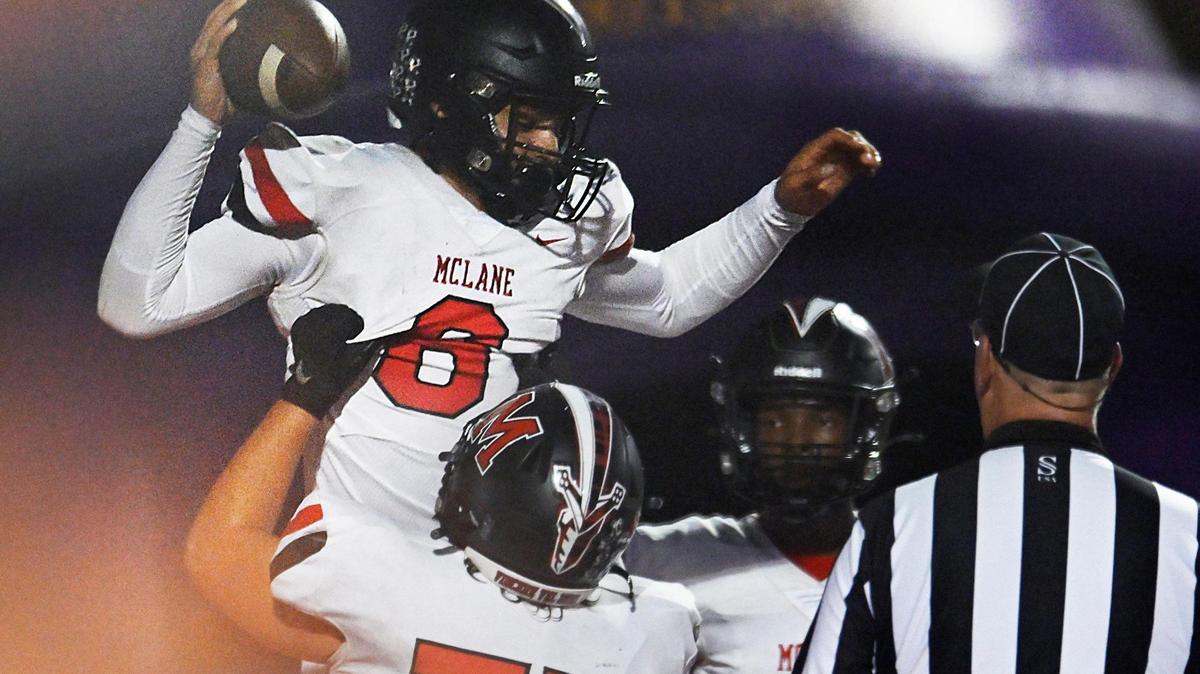 McLane quarterback Noah Zamora, top, is lifted high after running the ball in for a touchdown against Fresno Thursday, Sept. 14, 2023 in Fresno.
