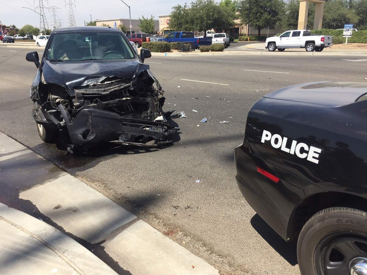 A black Saturn Vue was damaged on the front end after colliding with a Fresno police cruiser in northwest Fresno on Thursday.