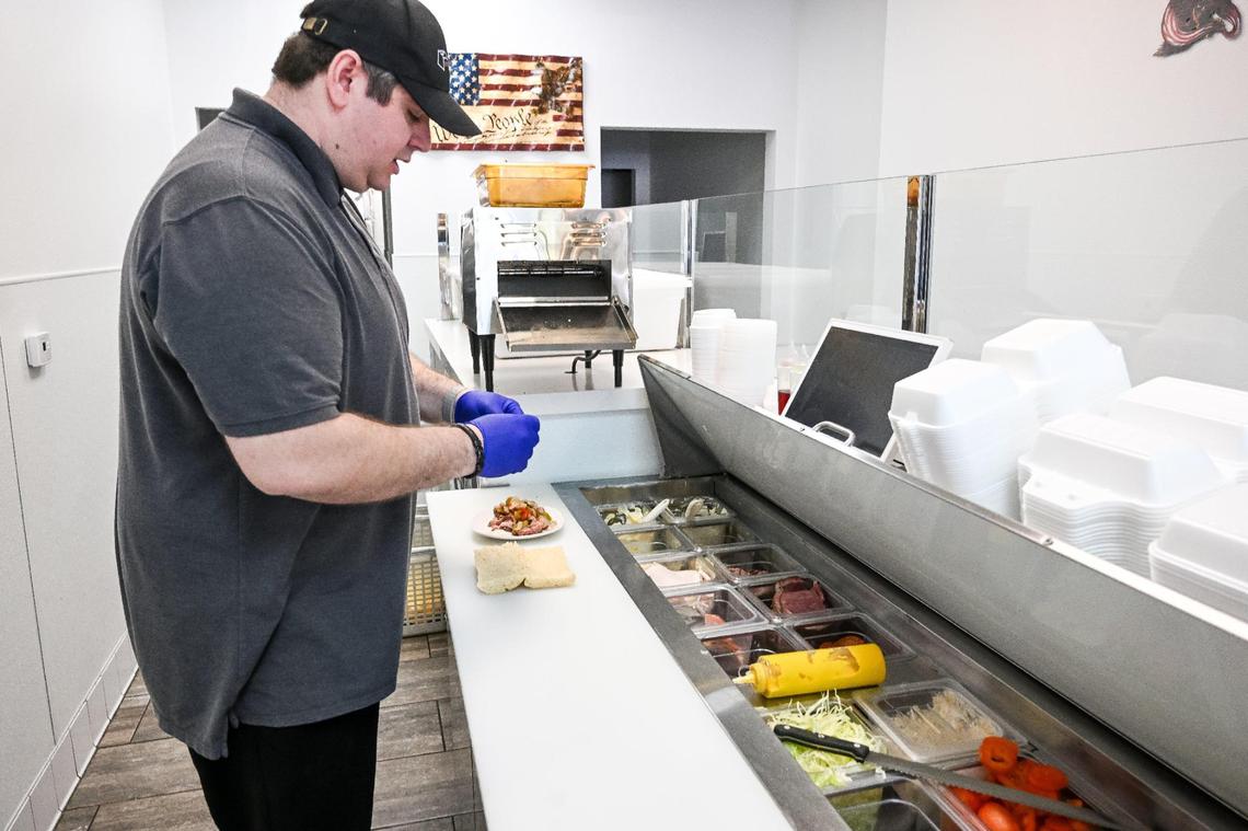 Arnold Karaoglan, owner of the Eagle Sandwich Co. in north Fresno, prepares a sandwich at his north Fresno shop.