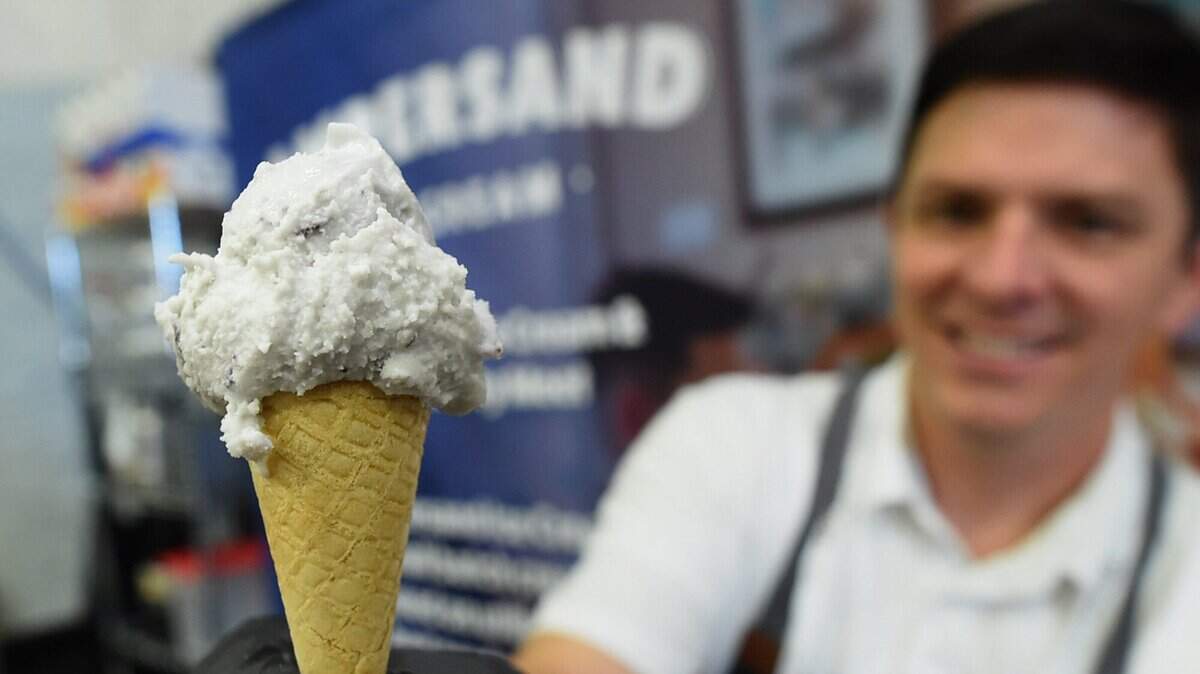 FILE - Jeff Bennett, owner of Ampersand Ice Cream, shows a sample of his honey blueberry ice cream, which tied for second place in the New Product Award category, during the Fresno Food Expo (now called the California Food Expo) on July 26, 2018.