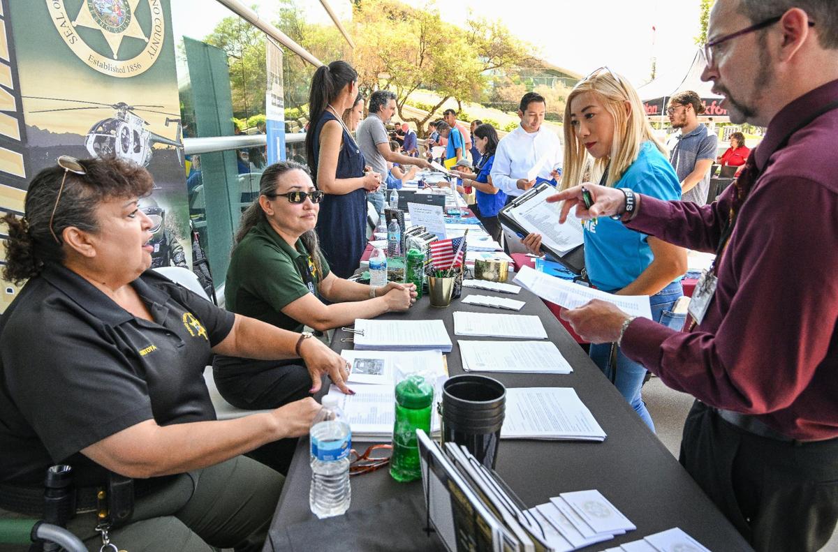 Job-seekers speak with prospective employers during a job fair hosted by Workforce Connection and the City of Fresno in response to the laying off of 300 Fresno employees from Bitwise Industries, at Fresno City Hall on Friday, June 16. 2023.