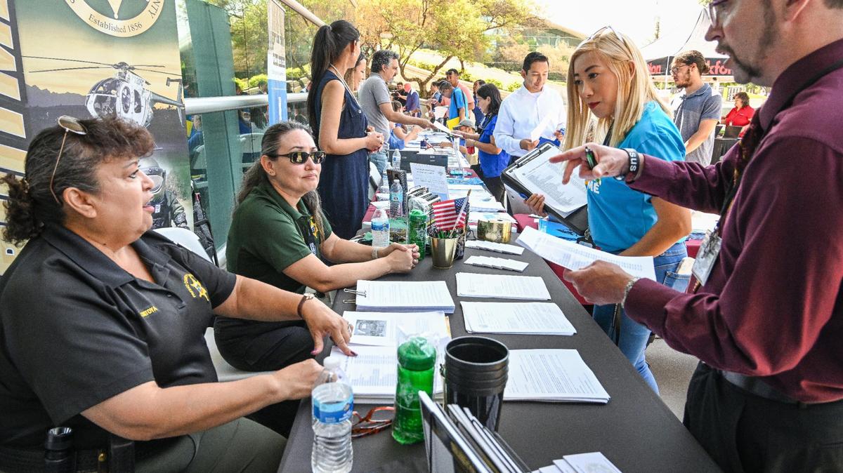 Job-seekers speak with prospective employers during a job fair hosted by Workforce Connection and the City of Fresno in response to the laying off of 300 Fresno employees from Bitwise Industries, at Fresno City Hall on Friday, June 16. 2023.