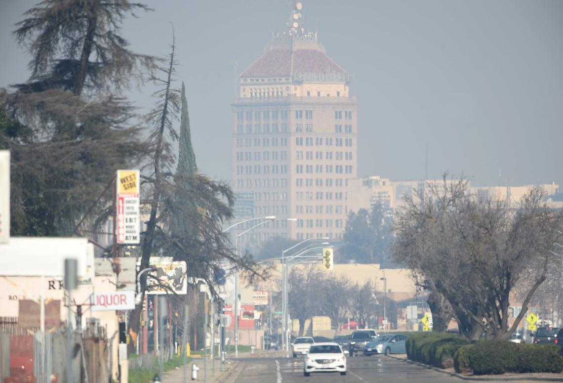 Pacific Southwest Building looms out of the bad air, late Friday morning, Jan. 25, 2019, looking north on Elm Avenue.