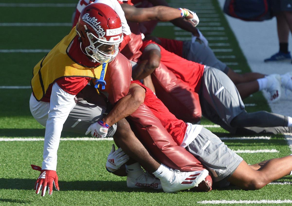 Bulldog players go through tackling drills on the first day of spring practice, Monday March 21, 2022.