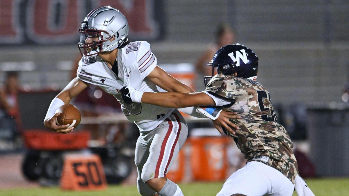 Torres High’s quarterback Jose Soriano, left, escapes the rush by Washington Union’s Joel Ramos, right, Friday, Sept. 1, 2023 in Easton.