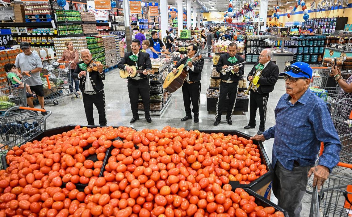 Mariachis entertain shoppers in the produce section during the grand opening of the new El Super supermarket on the north end of Manchester Center in Fresno on Wednesday, June 25, 2025.