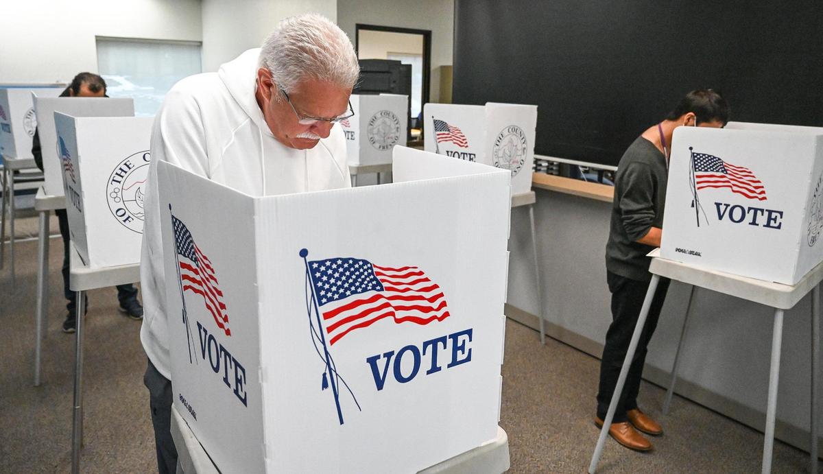 Mike Jones of Fresno fills out a voter ballot in-person at the downtown Fresno elections office prior to Tuesday’s general election, on Monday, Nov. 7, 2022.