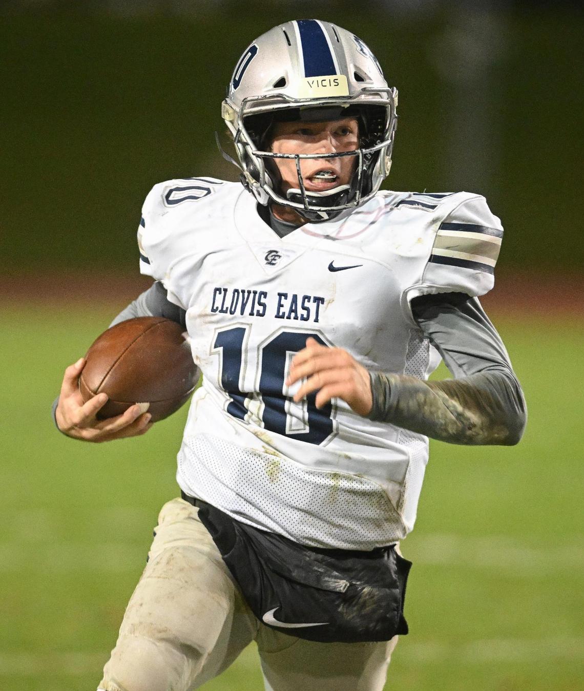 Clovis East quarterback Tyus Miller takes the ball around the end on a keeper against Clovis North in their Central Section Division I semifinal at Veterans Memorial Stadium on Friday, Nov. 17, 2023.